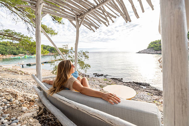 Woman Relaxing on Beachside Lounge Chair