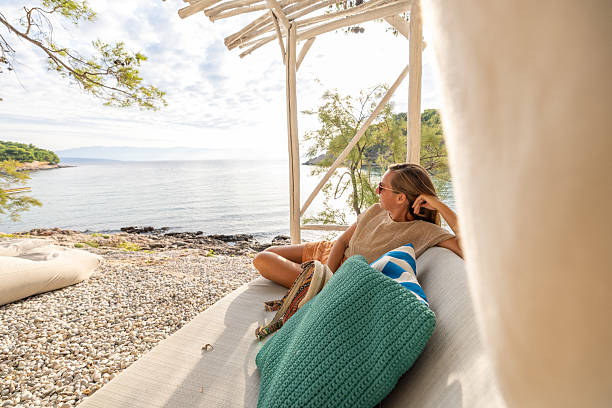 istock Woman Relaxing on Beachside Lounge Sofa 2232417889