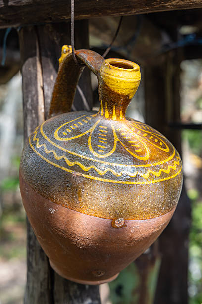 istock Traditional ceramic jug hanging from a fence. 2232419218