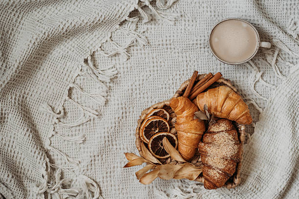 istock Croissants on heart tray on white cozy plaid 2232419343
