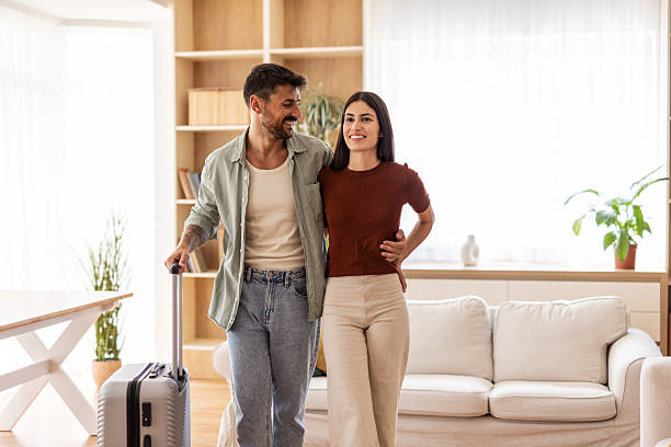istock Happy couple leaving home with suitcase for vacation 2232419908