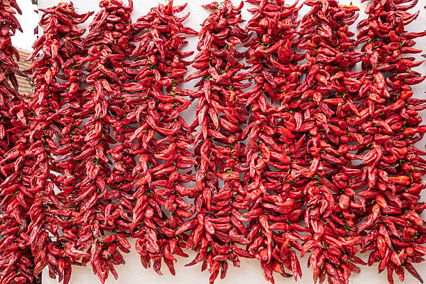 istock Strings of fresh red peppers hanging to dry. 2232420891