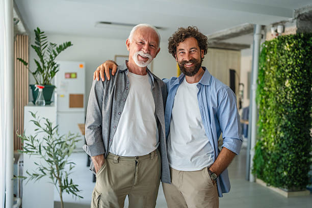 istock Father and son entrepreneurs smiling together in modern office 2232424001