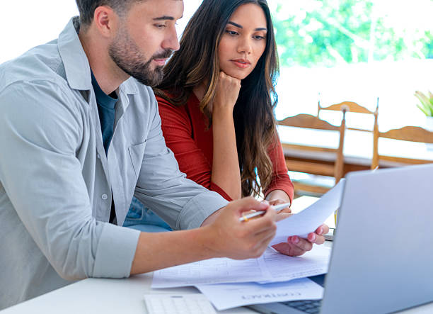 istock Young couple doing paperwork  and finances at home in the kitchen 2232427054
