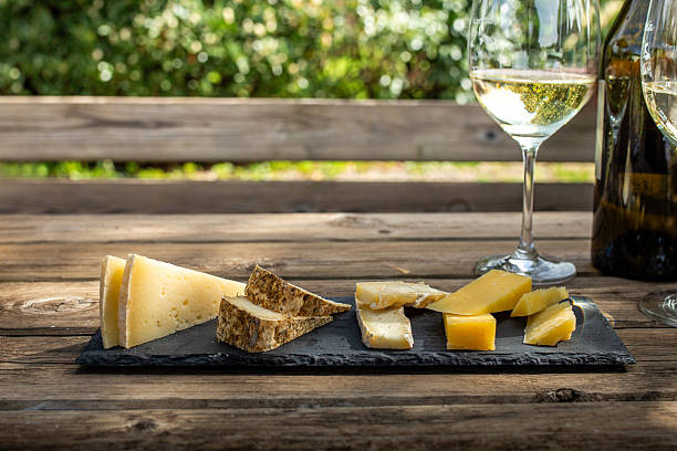 istock Cheese tasting on a slate board with white wine 2232428738