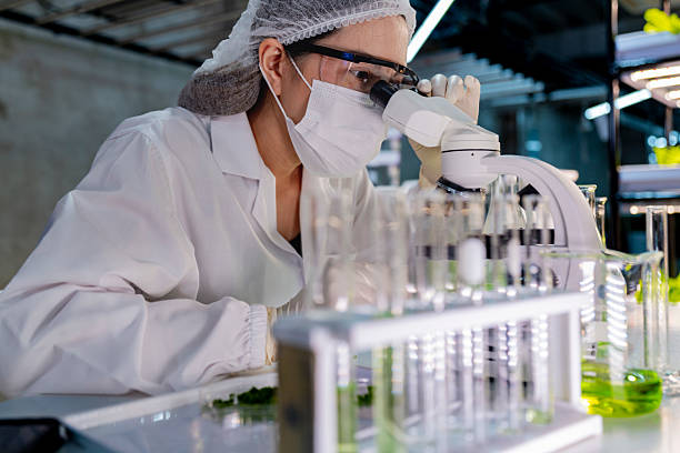 istock A researcher in a sterile lab conducts a scientific experiment using a microscope and test tubes. Cutting edge biotechnology and chemistry help develop breakthroughs in medicine and healthcare. 2232429774