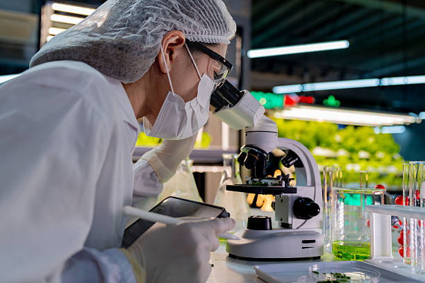 istock A researcher in a sterile lab conducts a scientific experiment using a microscope and test tubes. Cutting edge biotechnology and chemistry help develop breakthroughs in medicine and healthcare. 2232429841