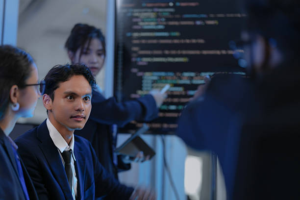 istock A female AI architect leads a strategy session, presenting the code for a new Generative AI model. Her diverse team discusses the system's architecture and path to AGI development. 2232431328
