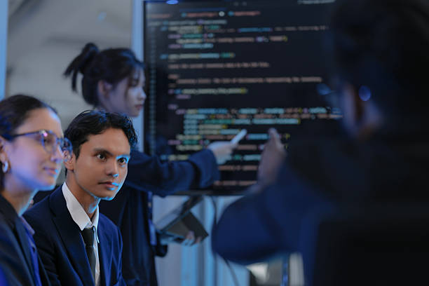 istock A female AI architect leads a strategy session, presenting the code for a new Generative AI model. Her diverse team discusses the system's architecture and path to AGI development. 2232432359