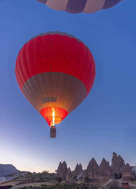 Colorful hot air balloons flying over Cappadocia. Love valley on the background ,Turkey