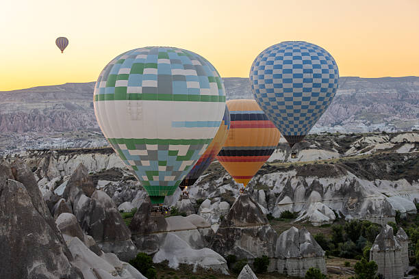 Colorful hot air balloons flying over Cappadocia. Love valley on the background ,Turkey