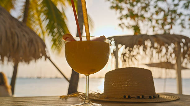 istock Fruit Cocktail and Straw Hat on Martinique Beach 2232434628