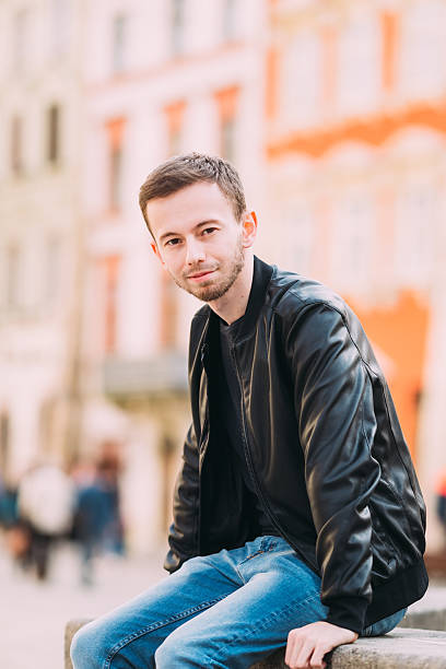 portrait of handsome man with beard in leather jacket look at camera.