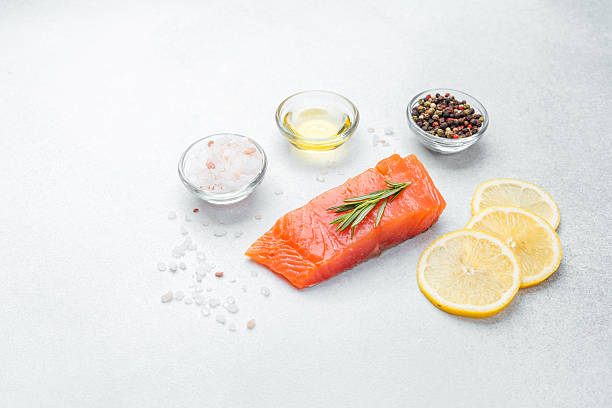 istock Fresh salmon fillet prepared with herbs and spices on a clean surface 2232435318
