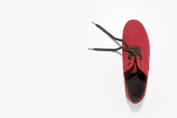 Climbing shoes isolated on red background.