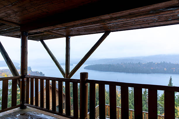 istock Rustic Balcony Overlooking Vast Misty Lake and Forested Hills 2232438527