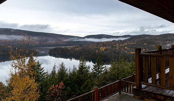 istock Serene Autumn Lake View From a Rustic Wooden Deck in a Mountain Landscape 2232438540