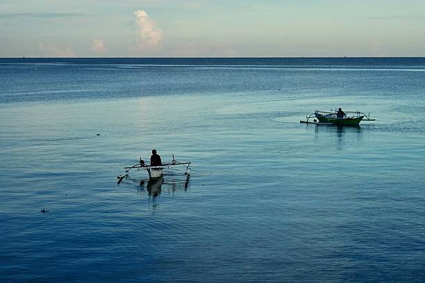Fishermen in Manado City, North Sulawesi, search for their livelihood as dusk approaches on Saturday (Agustus 9, 2025). The waters where they earn their living are currently threatened by a reclamation project.