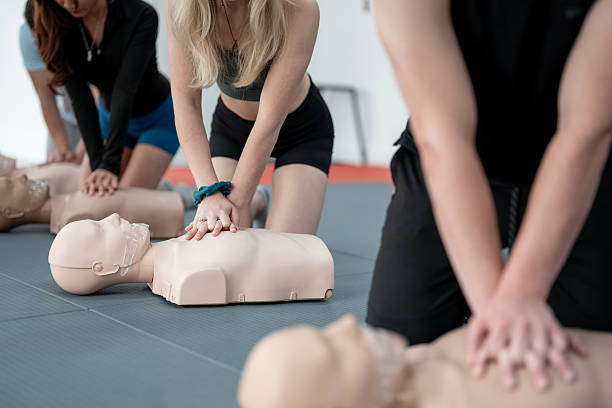 istock Group CPR Training Session with Mannequins on a Gym Floor 2232442721