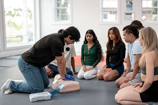 istock Instructor Demonstrating CPR Techniques to a Diverse Group of Pupils in Training 2232442794