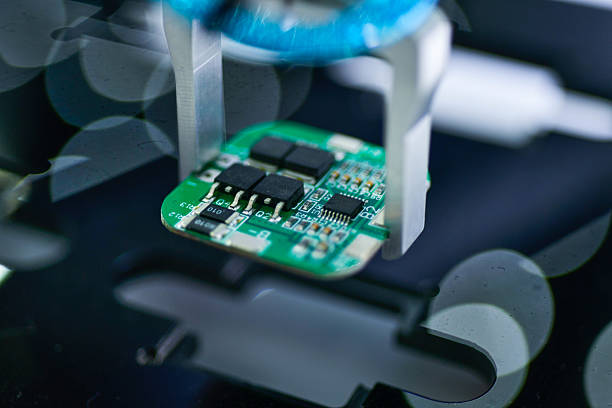 istock Modern Robot Arm automation system moving circuit boards in a factory 2232447878