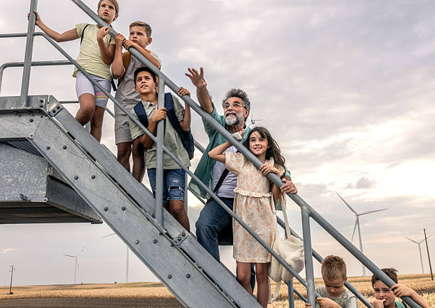 istock Kids learning about wind energy with teacher outdoors 2232448157