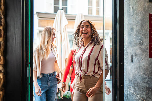 istock Diverse Young Women Arriving at Cozy Brunch Spot 2232451413