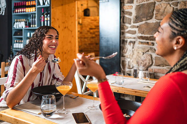 istock Young Hispanic and Diverse Friends Dining in Cozy Bistro 2232451419