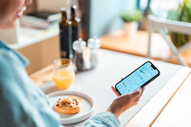 istock Multiracial Woman Completing Smartphone Payment in Cozy Bistro 2232452193