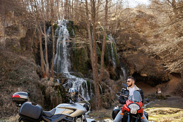 istock Young man enjoying road trip by his motorcycle through countryside 2232452567