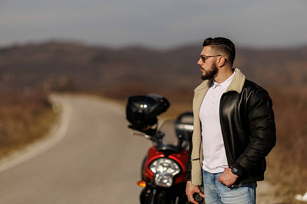 istock Young man with motorcycle breakdown on the road 2232452882
