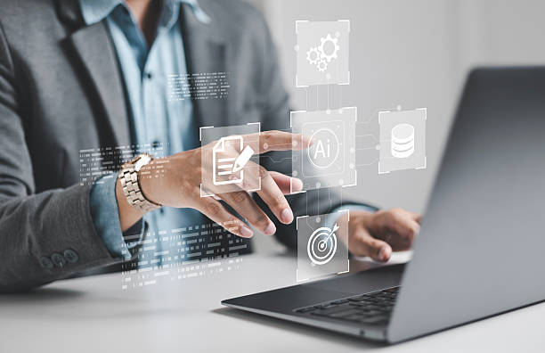 istock Businessman using laptop to control AI at desk in office. Artificial intelligence is analyzing data and generating reports. Artificial intelligence and intelligent automation (IA) technology. 2232456199