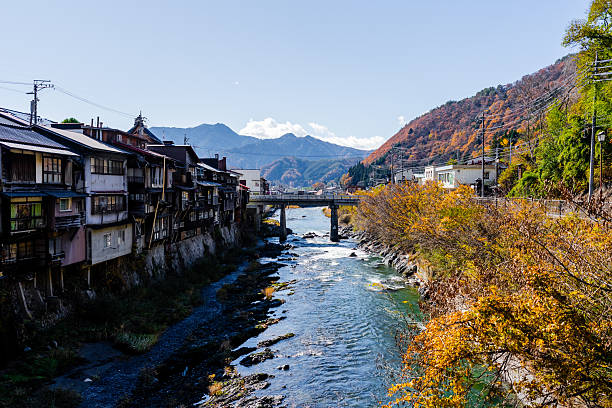 istock Riverside Village in Autumn (Japan) 2232457180