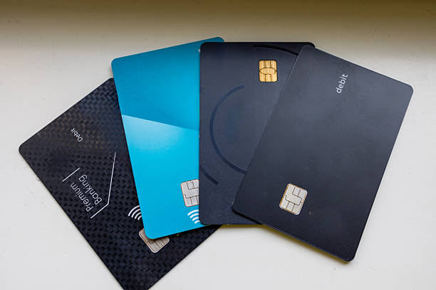 Flat lay of various modern debit and credit cards arranged in a fan pattern. A minimal and professional setup representing finance, banking, and digital payment systems.
