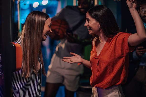 istock Two young women having fun playing virtual reality games in an arcade 2232457870