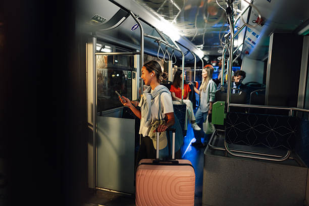 istock Young woman using smartphone while traveling by bus at night 2232457916