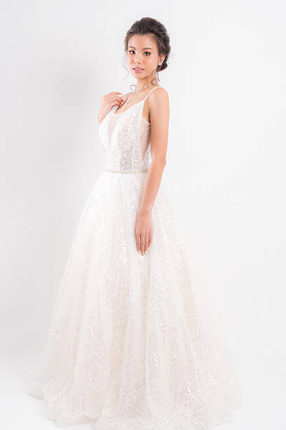 istock Bride in a shimmering white wedding gown. 2232459067