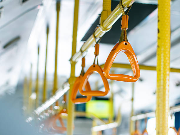 istock Passenger handholds and grab bars inside public transportation bus or train - safety support handles for commuters in urban transit vehicle. 2232459191