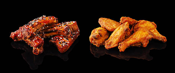 Delicious barbecue and crispy fried chicken served on a dark background