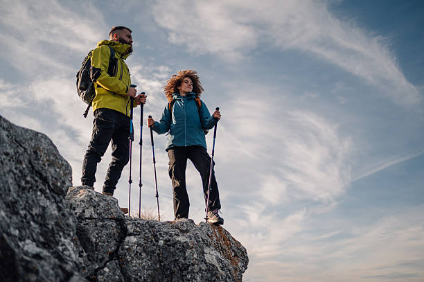 istock Hikers reaching mountain top enjoying scenic view 2232461388