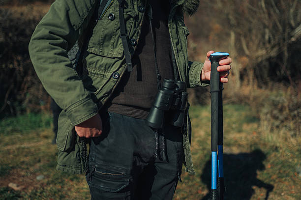 istock Hiker exploring nature with binoculars and trekking poles 2232463724