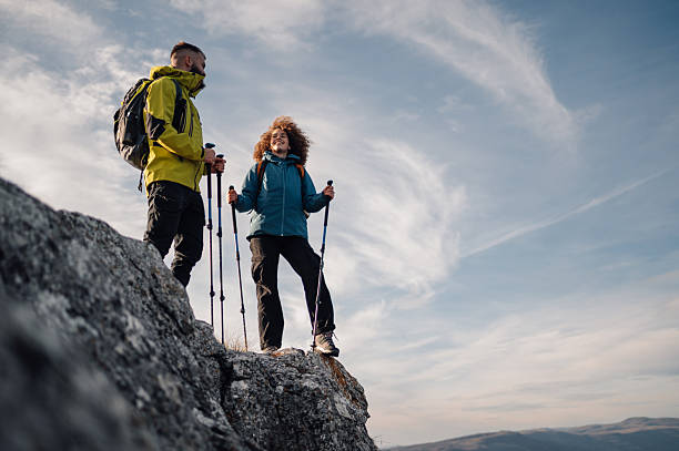 istock Hikers standing on mountain top enjoying scenic view 2232463765