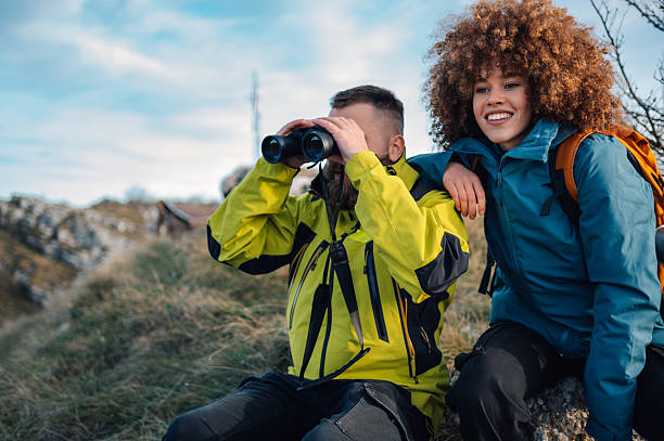 istock Hikers observing nature with binoculars in the mountains 2232463768