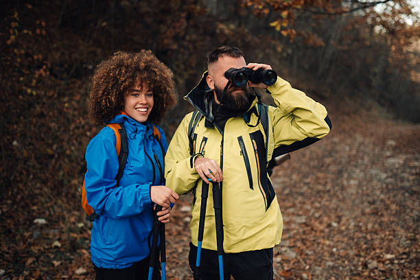 istock Hikers observing nature with binoculars in autumn forest 2232463987