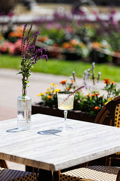 istock Summer cocktail on outdoor cafe table with flowers 2232464150