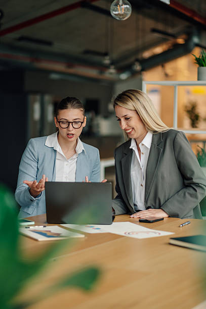 istock Businesswomen discussing work on laptop in office 2232464232