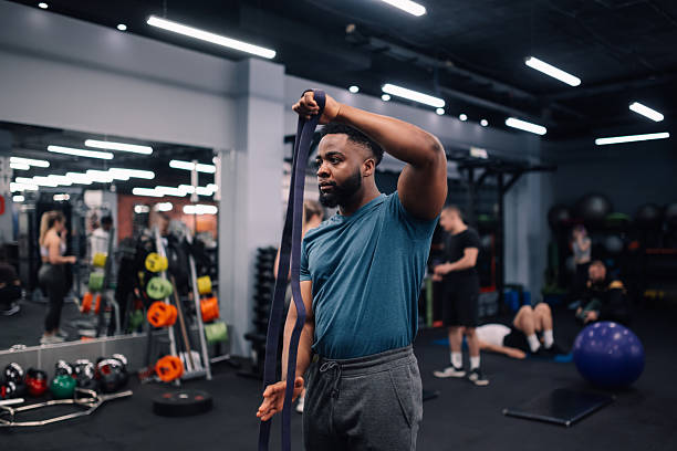 istock Young man stretching resistance band at gym 2232464366