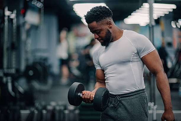 istock Determined bodybuilder lifting dumbbell in gym 2232464522