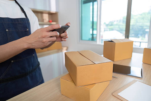 istock Inventory management. Young man checking stock on smartphone in workspace. 2232464960
