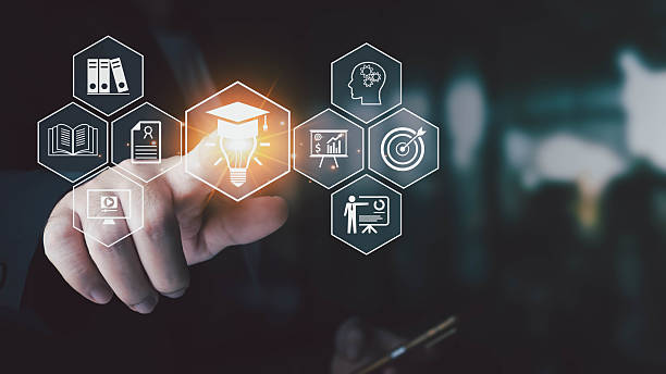 istock A businessman touches a virtual interface, selecting a glowing lightbulb with a graduation cap, symbolizing e-learning, online education, and skill development. 2232465381